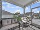 Screened-in patio with wicker furniture set offers a relaxing outdoor living space at 3317 Black Cherry Dr, Monroe, NC 28110