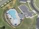Overhead shot of community pool with lounge seating, surrounded by grass at 3317 Black Cherry Dr, Monroe, NC 28110