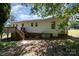 Spacious backyard featuring a deck, some foliage, a little bit of brick, and a well-maintained lawn at 38367 Loblolly Ln, New London, NC 28127