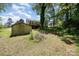 Expansive backyard featuring a deck, shed, mature trees, and lush greenery at 38367 Loblolly Ln, New London, NC 28127