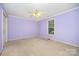 Bright bedroom with lilac-colored walls and a ceiling fan with lights at 38367 Loblolly Ln, New London, NC 28127