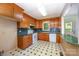 Traditional-style kitchen with wood cabinets, white appliances, and patterned flooring at 38367 Loblolly Ln, New London, NC 28127