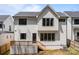 A view of the back exterior of the home with a wood deck and stairs at 3937 Plainview Rd, Charlotte, NC 28208