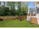 A spacious backyard featuring a fire pit area and mature trees at 3937 Plainview Rd, Charlotte, NC 28208