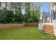A spacious backyard featuring a fire pit area and mature trees at 3937 Plainview Rd, Charlotte, NC 28208