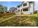 Large backyard with fresh sod and a modern home exterior featuring ample windows at 3937 Plainview Rd, Charlotte, NC 28208