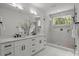 Elegant bathroom featuring double vanity, glass shower with marble tile, and modern fixtures at 3937 Plainview Rd, Charlotte, NC 28208