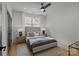 Comfortable bedroom with a cozy bed, soft rug, ceiling fan, and natural light from the window at 3937 Plainview Rd, Charlotte, NC 28208