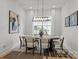 Elegant dining room featuring modern light fixture and neutral decor at 3937 Plainview Rd, Charlotte, NC 28208