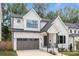 Beautiful modern farmhouse with white siding, black trim, and a two-car garage at 3937 Plainview Rd, Charlotte, NC 28208
