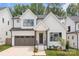 Beautiful modern farmhouse with white siding, black trim, and a two-car garage at 3937 Plainview Rd, Charlotte, NC 28208