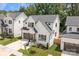 Aerial view of modern farmhouse, showcasing the well-manicured lawn and fenced yard at 3937 Plainview Rd, Charlotte, NC 28208