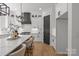 Stylish kitchen showcases an island with seating, stainless steel appliances, and sleek white cabinetry at 3937 Plainview Rd, Charlotte, NC 28208