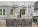 Bright kitchen features a large island with seating, stylish pendant lights, and views of the outdoor scenery at 3937 Plainview Rd, Charlotte, NC 28208
