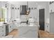 Modern kitchen with white cabinets, large island, and stainless steel appliances at 3937 Plainview Rd, Charlotte, NC 28208