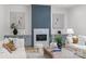 Modern living room with a decorative fireplace, chic decor, and comfortable seating arrangement at 3937 Plainview Rd, Charlotte, NC 28208