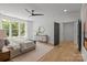 Stylish main bedroom featuring a plush bed, hardwood floors, and windows with a view at 3937 Plainview Rd, Charlotte, NC 28208