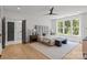 Inviting main bedroom featuring a padded headboard, hardwood floors, and large windows with natural light at 3937 Plainview Rd, Charlotte, NC 28208