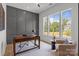 Stylish office with a large window and a board and batten accent wall at 3937 Plainview Rd, Charlotte, NC 28208