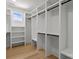 Spacious walk-in closet featuring custom shelving, hanging rods, and ample storage space for organization at 3937 Plainview Rd, Charlotte, NC 28208