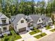 Aerial view of newly constructed homes featuring white siding, black trim, and manicured lawns at 3945 Plainview Rd, Charlotte, NC 28208