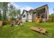 Spacious backyard with fire pit, lounge chairs and cornhole game at 3945 Plainview Rd, Charlotte, NC 28208