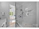Modern bathroom with a glass-enclosed shower and view to the bedroom at 3945 Plainview Rd, Charlotte, NC 28208