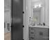 Elegant powder room featuring modern fixtures, grey vanity, and white walls at 3945 Plainview Rd, Charlotte, NC 28208