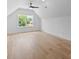 Spacious bedroom with vaulted ceiling, large window, and light wood floors at 3945 Plainview Rd, Charlotte, NC 28208