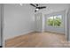 Bedroom with hardwood flooring, a ceiling fan, and natural light from two windows at 3945 Plainview Rd, Charlotte, NC 28208
