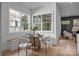 A sunny breakfast nook featuring a round table, stylish chairs, and bright windows with a glimpse of the outdoor scenery at 3945 Plainview Rd, Charlotte, NC 28208