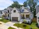 Stunning two-story home featuring white siding, black trim, and a well-manicured lawn at 3945 Plainview Rd, Charlotte, NC 28208