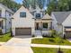 Inviting two-story home featuring white siding, black trim, and well-manicured lawn at 3945 Plainview Rd, Charlotte, NC 28208