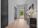 Inviting foyer with hardwood floors, black pane doors, and stylish console table near the entrance at 3945 Plainview Rd, Charlotte, NC 28208