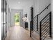 Bright foyer featuring hardwood floors, modern staircase, and stylish console table near the front door at 3945 Plainview Rd, Charlotte, NC 28208