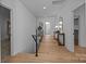 Bright hallway with wood floors, black metal railing, and stylish decor at 3945 Plainview Rd, Charlotte, NC 28208