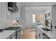 Bright, spacious kitchen featuring stainless steel appliances, white cabinets, and modern countertops at 3945 Plainview Rd, Charlotte, NC 28208