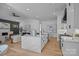Open concept kitchen with large island, modern appliances, and seamless flow to the living area at 3945 Plainview Rd, Charlotte, NC 28208