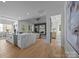 Open concept living space with the kitchen featuring a large island and views of the fireplace and living area at 3945 Plainview Rd, Charlotte, NC 28208