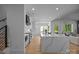 Bright, open kitchen with a large island, stainless steel appliances, and modern finishes with easy access to the living room at 3945 Plainview Rd, Charlotte, NC 28208