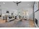 Open-concept living room with a view to kitchen, stylish furniture, and large windows at 3945 Plainview Rd, Charlotte, NC 28208