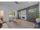 Bright living room featuring a modern fireplace, light wood floors, and ample natural light at 3945 Plainview Rd, Charlotte, NC 28208