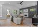 An open living room with vaulted ceilings, fireplace, modern furniture, and natural light through the windows at 3945 Plainview Rd, Charlotte, NC 28208