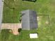 Aerial view of the home showcasing the roof, backyard, driveway, storage shed, and the surrounding lush greenery at 402 Beaver Dam Church Rd, Shelby, NC 28152
