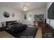 Virtually staged bedroom includes a large bed, accent furniture, and a dedicated workspace with shelves and desk at 402 Beaver Dam Church Rd, Shelby, NC 28152