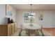 Virtually staged dining room includes a modern table with seating for four and a stylish sideboard with decor at 402 Beaver Dam Church Rd, Shelby, NC 28152