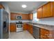 Functional kitchen featuring stainless steel appliances, wood cabinets, and a tile floor at 402 Beaver Dam Church Rd, Shelby, NC 28152