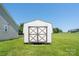 A well-kept outbuilding with white walls and brown trim sits in the yard at 402 Beaver Dam Church Rd, Shelby, NC 28152