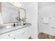 This bathroom features a white vanity, and large mirror at 4474 Pebblebrook Sw Cir, Concord, NC 28027