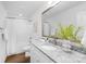 The bathroom has a modern vanity with white cabinets, granite countertop and tub with shower at 4474 Pebblebrook Sw Cir, Concord, NC 28027